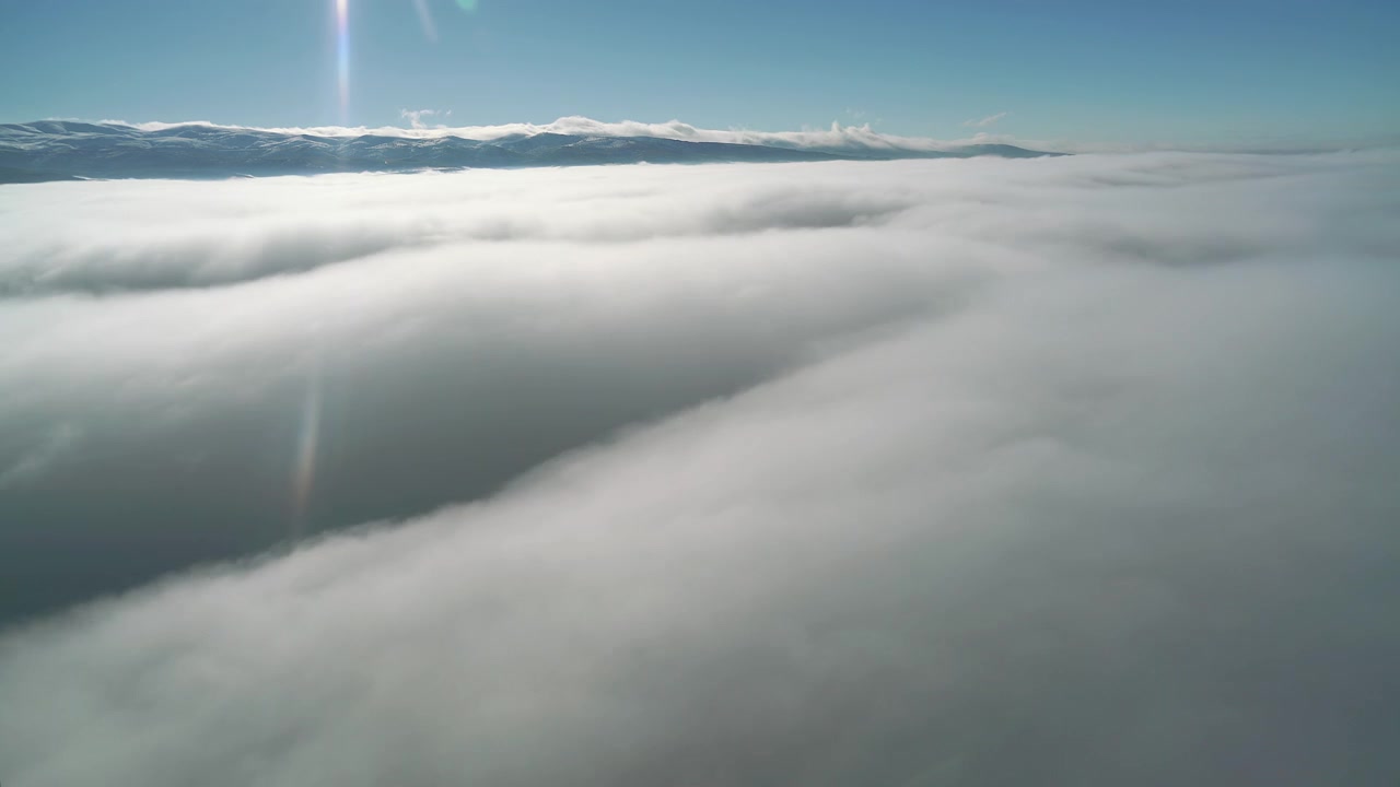 Aerial View of Thick Clouds Over Mountain Range