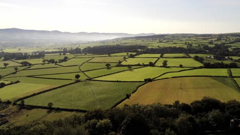 beautiful misty welsh countryside rural patchwork sunrise landscape aerial view right pan