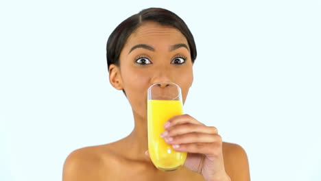 woman drinking a glass of orange juice