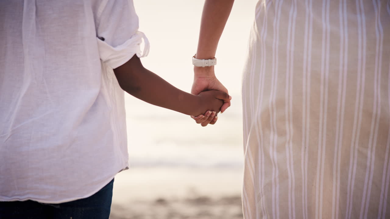 Love, mother and child holding hands at beach