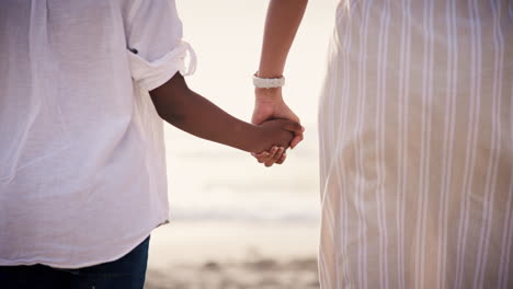 Love,-mother-and-child-holding-hands-at-beach
