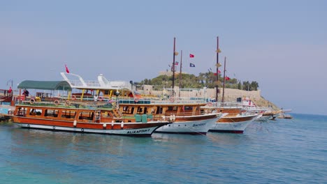 tourist boats moored on mediterranean sea coast in kusadasi, turkey