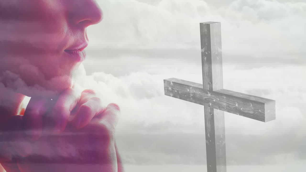 Praying person holding cross with animation of cloudy sky background