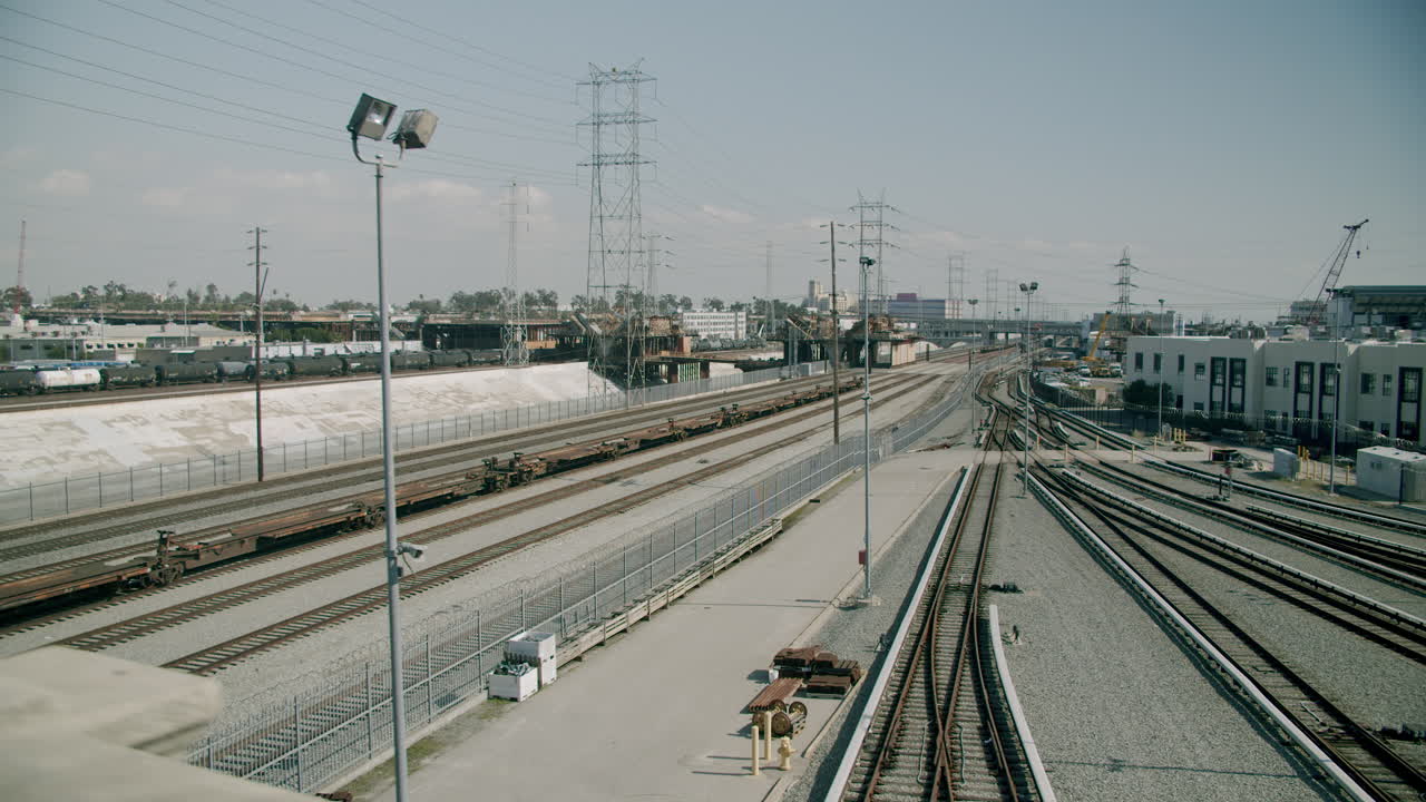 Extensive network of train tracks and power lines in an industrial area