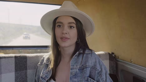 a young female having fun during a roadtrip in the caravan