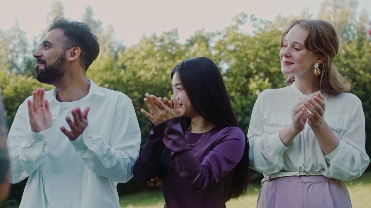 Group of people applauding outdoors