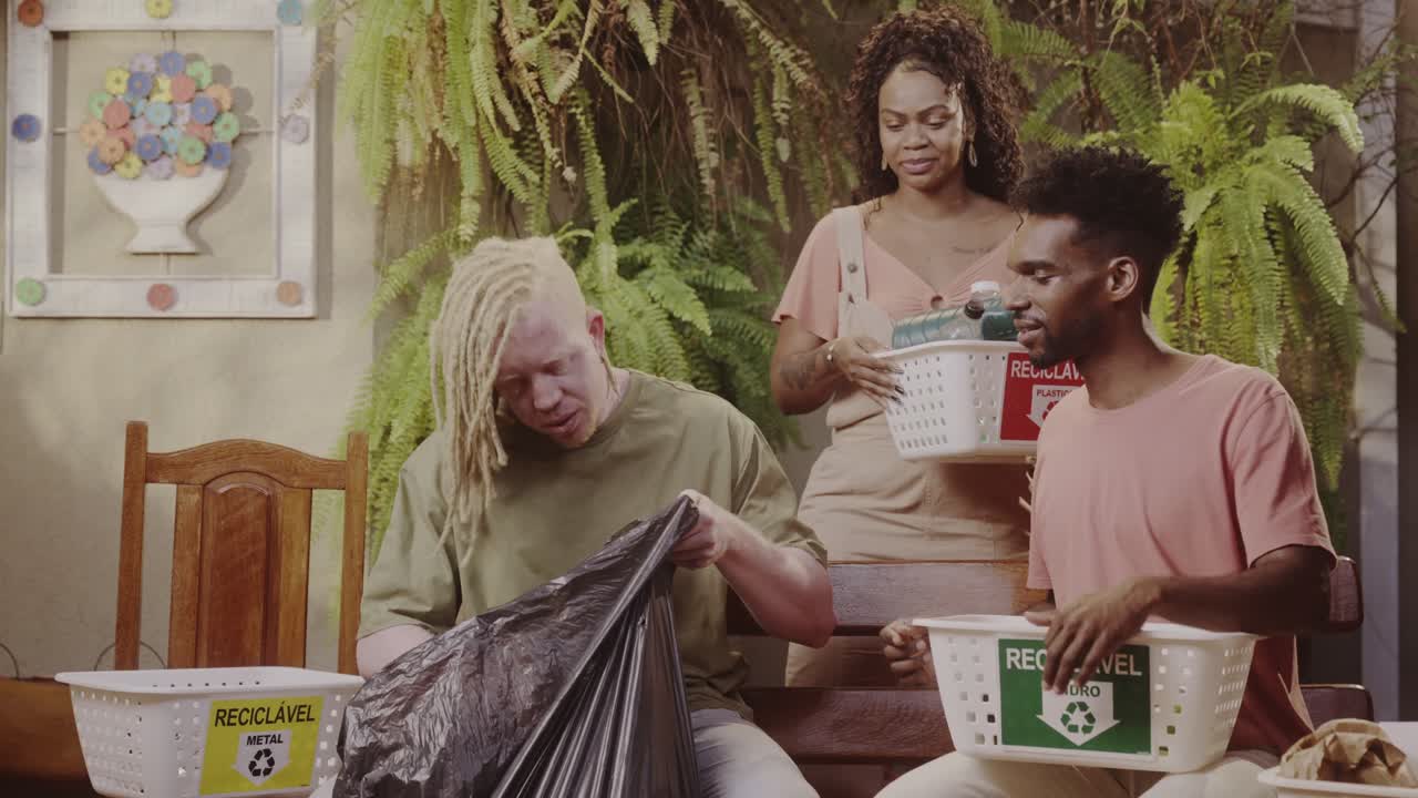 People actively sorting trash into recycling bins for metal, glass, and plastic, demonstrating environmental responsibility