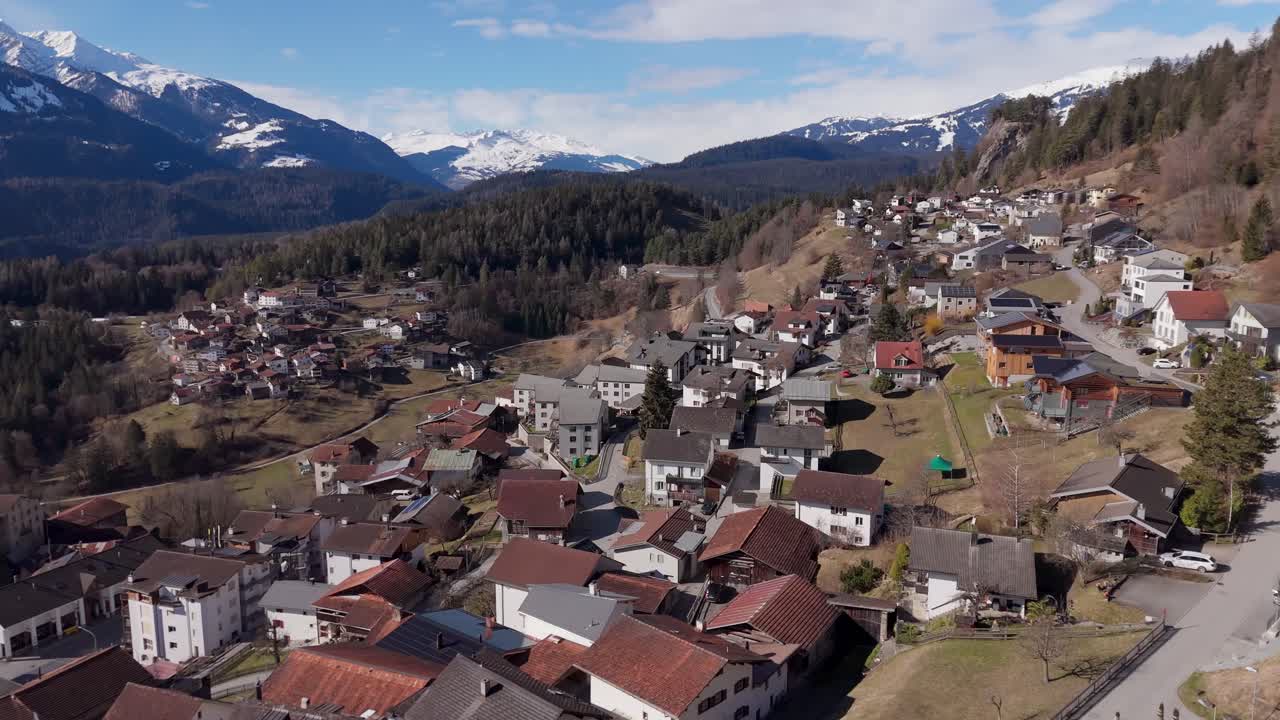 Trin, switzerland with scenic mountains, houses, and countryside, aerial view
