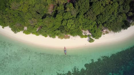 aerial view of longtail boat at sandy beach in thailand - camera pedestal up and backwards tracking