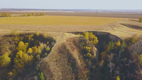 steep ravines with grass woods and couple on crest aerial