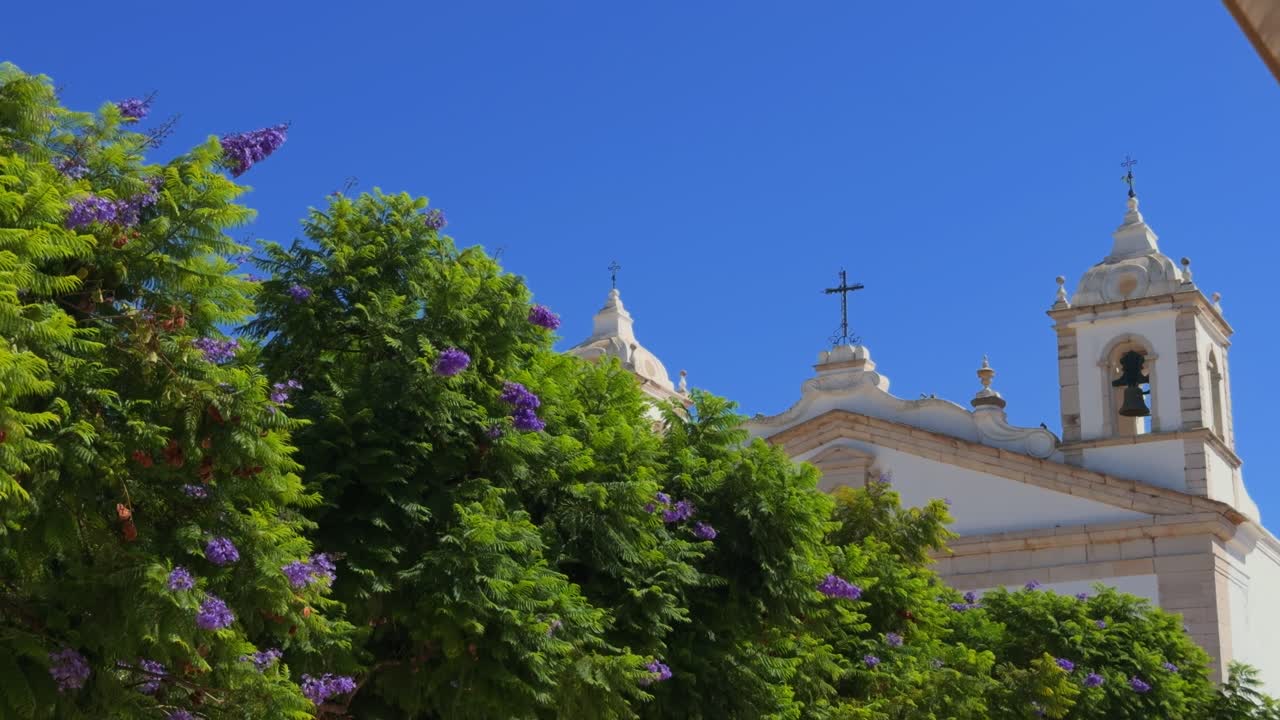 Algarve Epic locations blue sky, church and verdant trees Lagos Portugal in summer