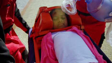 paramedics examining injured girl