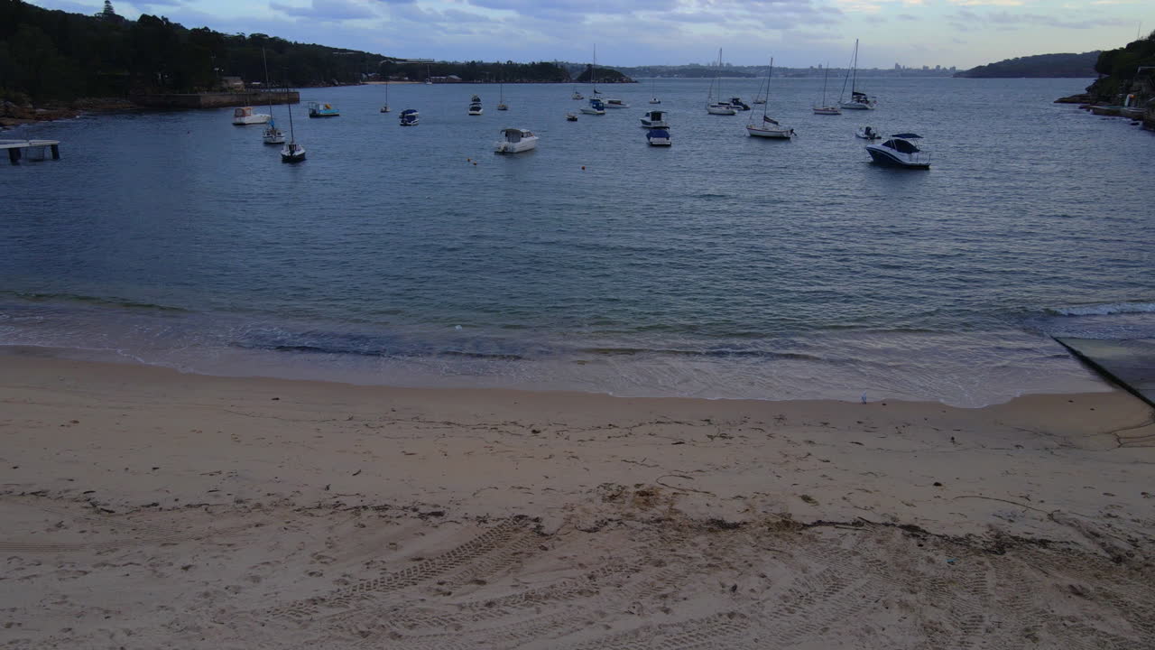 Rising Drone shot of Boats anchored off a beach
