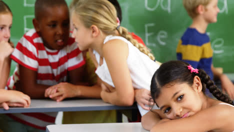 school kids interacting with each other in classroom