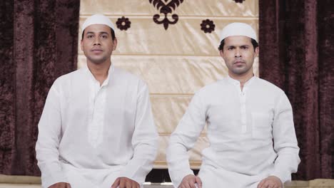 muslim men doing ramadan prayer at home