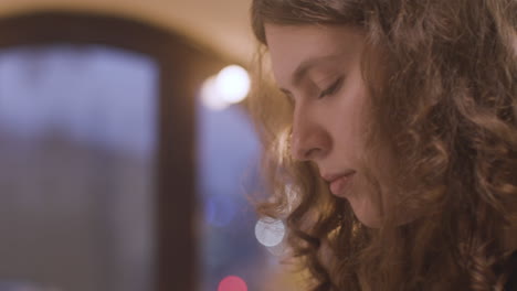 close up of curly woman playing piano 2