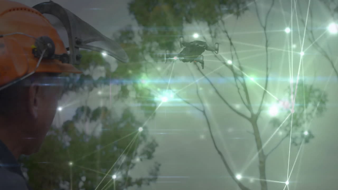 Man wearing hard hat observing quadcopter drone in forest tech, featuring glowing network interface