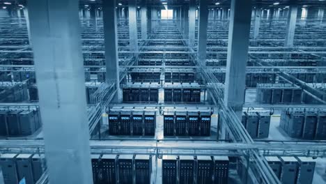 aerial view of a vast server farm with rows of server racks and complex cabling systems, highlighting the scale and infrastructure of modern data centers