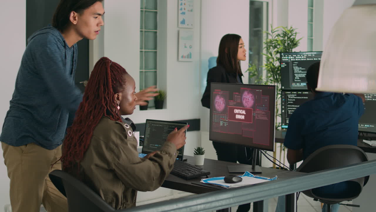 Diverse team of app developers having computer hacked and writing code