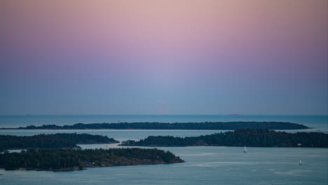 Time-lapse-of-the-moon-rising-over-the-Helsinki-archipelago,-dusk-in-Finland