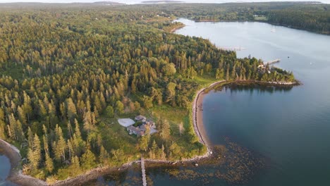 houses and docks along scenic coastline in penobscot bay, maine | aerial panning view | summer 2021