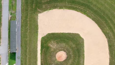 an empty baseball court near the school