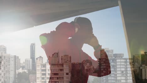 Animation-of-african-american-man-wearing-headphones-over-cityscape