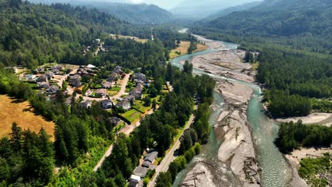 idyllic neighborhood and evergreen forest landscape in chilliwack river valley, british columbia, canada