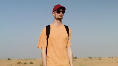 man with black backpack posing