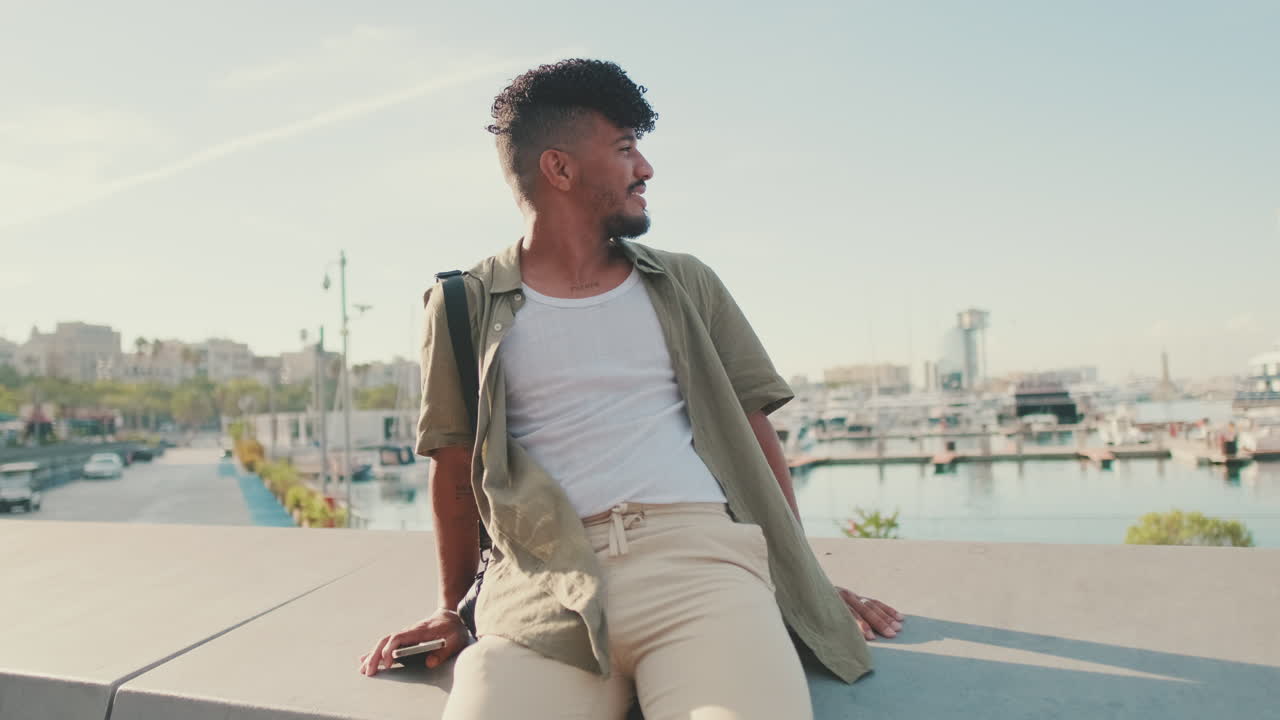 Man sitting by the harbor