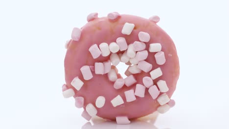 pink glazed marshmallow donut. bright and colorful sprinkled donut on a white background. assortment of donuts of different flavors