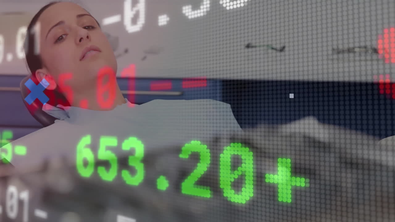 Female patient wearing dental bib reclining in chair, showing floating stock market numbers overlay