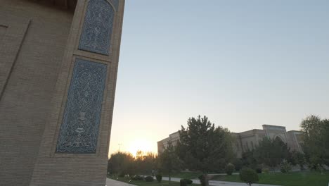 central asian architecture and trees on the sunset