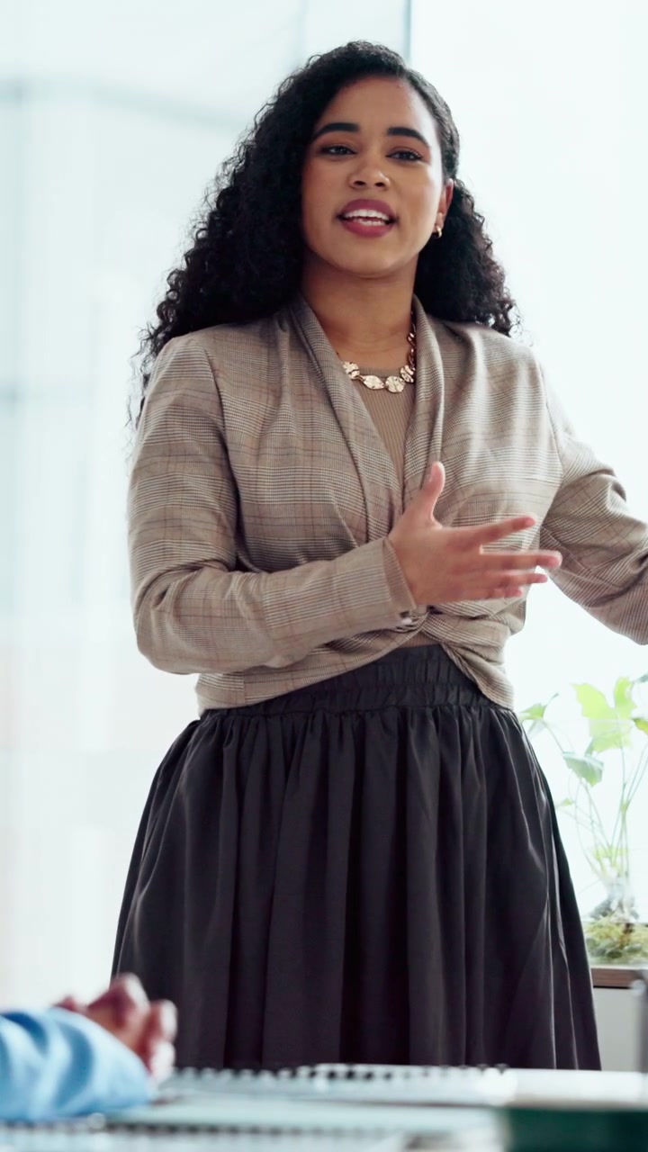 Professional Woman Giving a Presentation in an Office Meeting