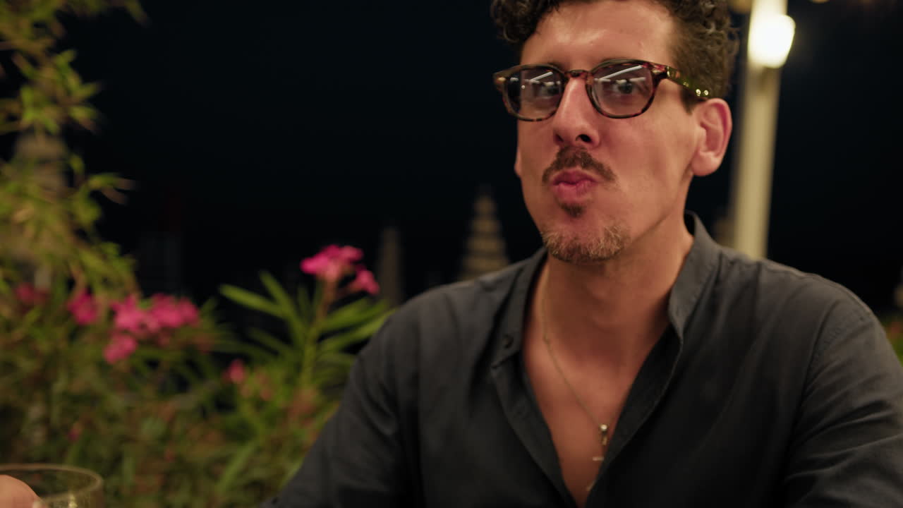 Man Eating With His Hands Squid Appetizer During Beach Resort Dinner