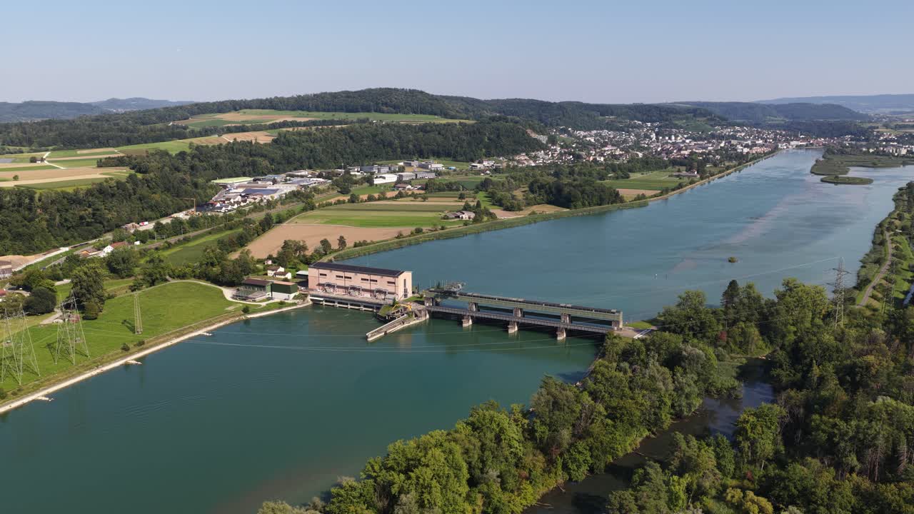 Hydroelectric power plant, electricity from water. River in Switzerland. Clean green energy from nature. Renewable energy resource. Aerial video