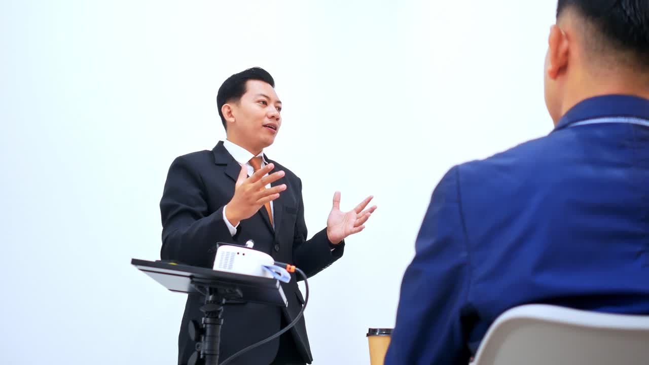 Confident businessman passionately presenting ideas to colleagues in modern meeting room