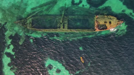aerial view of shipwreck with kayaker