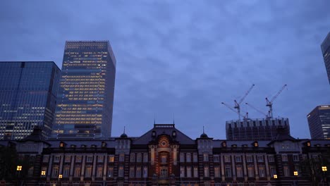 Famous-Tokyo-Station-at-night-with-skyscrapers-in-background---static-shot-with-copyspace