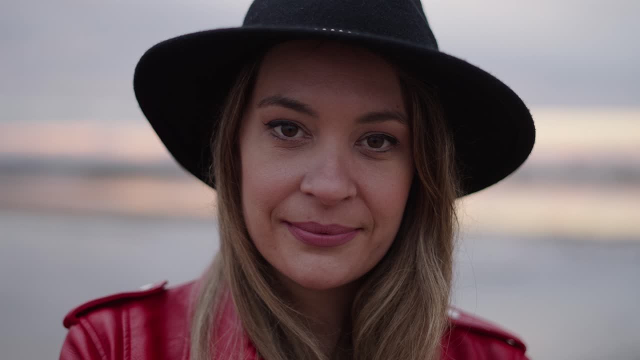 Woman in a hat and red jacket