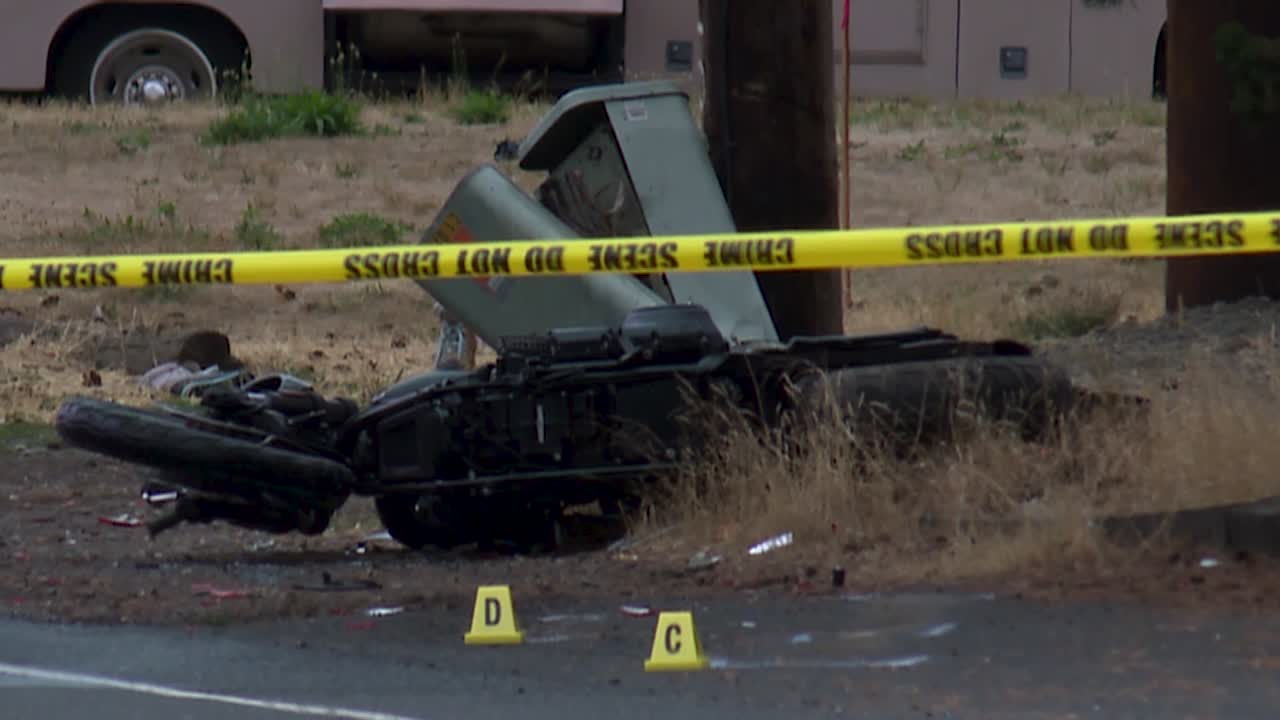 AFTERMATH OF MOTORCYCLE CRASH BEHIND POLICE TAPE