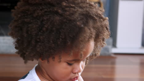 Young-black-girl-making-face-and-playing-with-plastic-rings