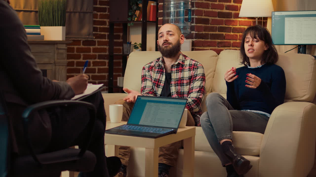 Married people attending therapy session with psychologist
