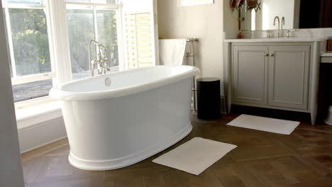 freestanding bathtub in modern bathroom with large window, creating serene atmosphere
