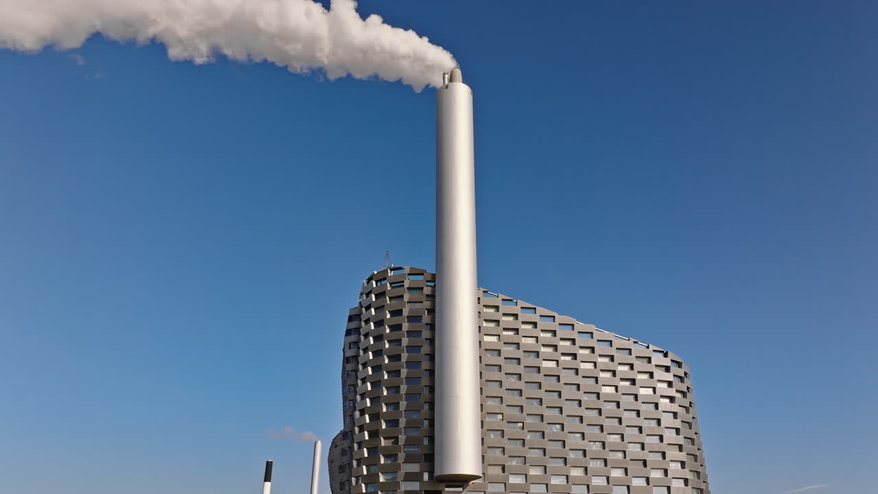 Aerial drone view of CopenHill artificial ski slope on the roof of an energy plant