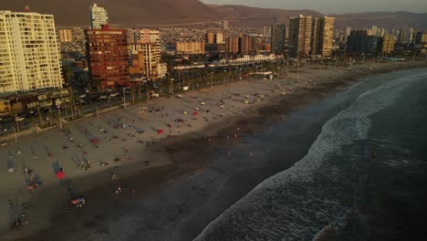 aerial view of iquique, chile, waterfront and beach on pacific ocean at sunset