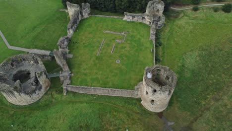 flint castle welsh medieval coastal military fortress ruin aerial view descending tracking shot