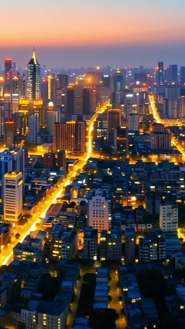 Dusk skyline with twinkling lights. Dusk city skyline with glowing lights and buildings silhouetted against a vibrant sunset.