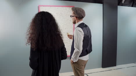 couple viewing modern art at an exhibition