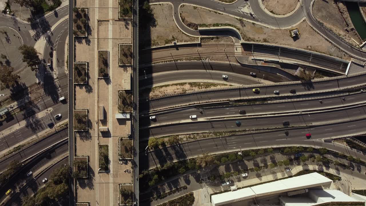 "Stationary aerial view of a bustling highway captured in stunning 4K. The shot highlights urban infrastructure, traffic flow, and road networks, ideal for urban, travel, or cinematic projects."